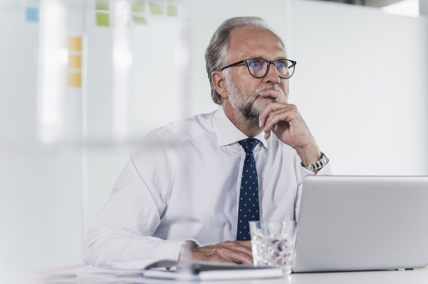 Mature Businessman With Laptop At Desk In Office Thinking - Control Service Contabilidade